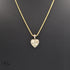 Gold necklace with a heart-shaped pendant on a black background